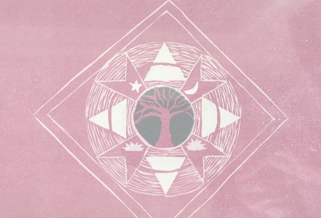 Jill Wagner's woodblock print: a tree inside a star mandala on pink paper